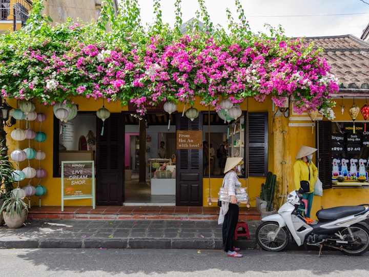 A flower-draped street in Southeast Asia